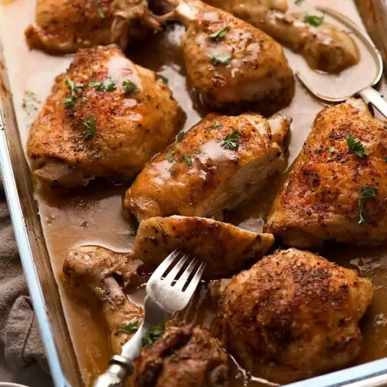 Delicious baked chicken served with savory gravy on a plate.